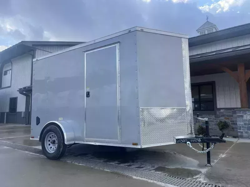 2026 Quality Cargo 6x12 Single Axle Enclosed Cargo Trailer 2990# GVW * 6'3 CEILING HEIGHT * SILVER EXTERIOR * PLYWOOD WALLS AND FLOOR * RV DOOR * 16" O.C. * TUBE STUDS * RAMP DOOR * V-NOSE