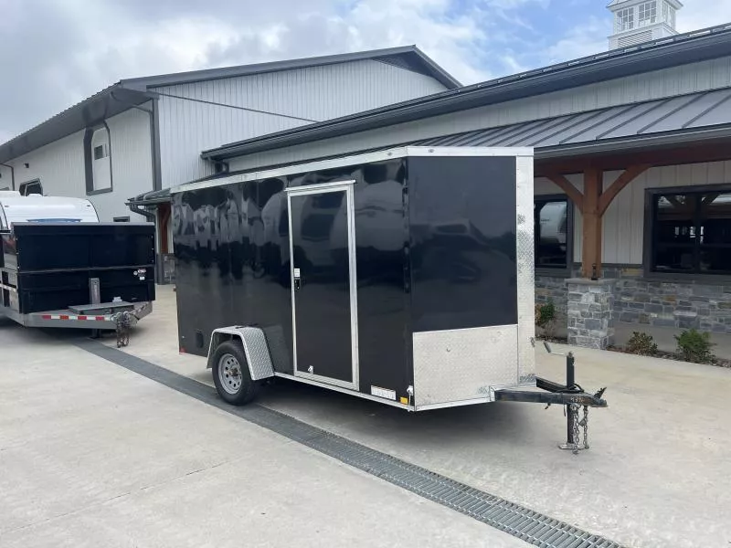 USED 2023 Xtreme Cargo 6x12' Enclosed Cargo Trailer 2990# GVW * 6'3" HEIGHT * 16" FLOOR CROSSMEMBERS * BLACK EXTERIOR * .030 SEMI-SCREWLESS * RV DOOR * PLYWOOD WALLS AND FLOOR * TUBE STUDS