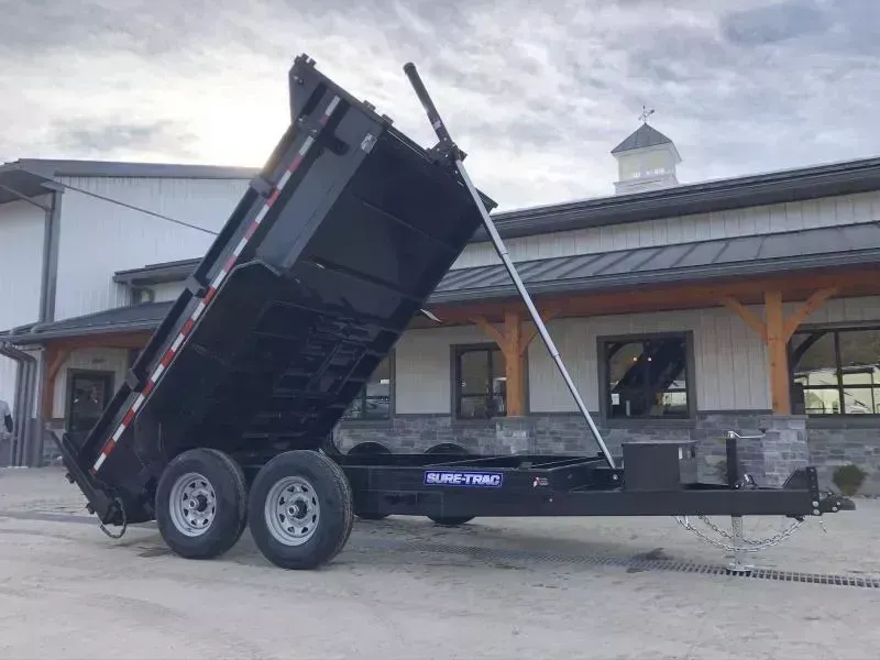 2026 Sure-Trac 7x12' Dump Trailer 12000# GVW * DERATED TO 9900# * TARP KIT * TELESCOPIC HOIST * FRONT/REAR BULKHEAD * INTEGRATED KEYWAY * 2' SIDES * UNDERBODY TOOL TRAY * ADJUSTABLE COUPLER * 110V CHARGER * UNDERMOUNT RAMPS * COMBO GATE * DROP LEG JACK