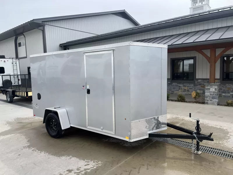 2025 Pace American 6x12' Enclosed Cargo Trailer 2990# GVW * SILVER EXTERIOR * 4" TONGUE AND FRAME * .030 SEMI-SCREWLESS EXTERIOR * TUBE STUDS * 1 PIECE ALUMINUM ROOF * UNDERCOATING * RAMP DOOR