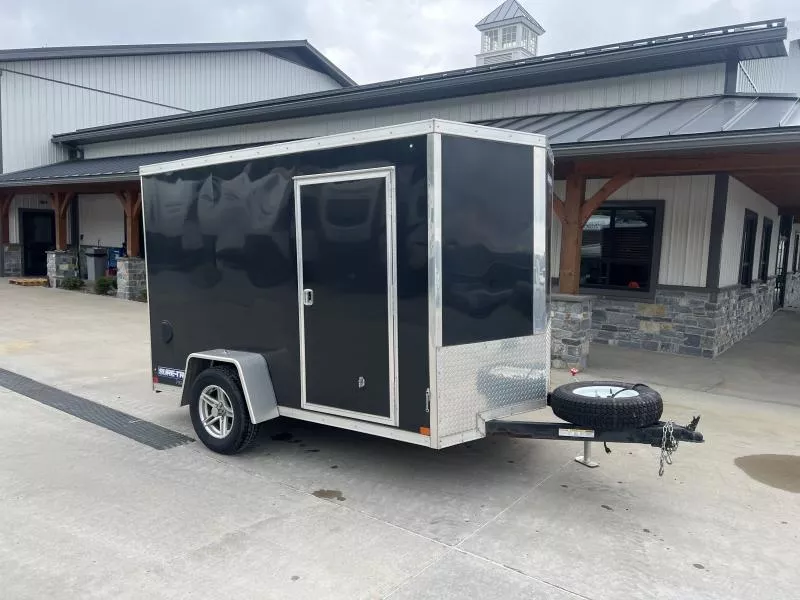USED 2022 Sure-Trac 6x10' Pro Series Enclosed Cargo Trailer 2990# GVW * BLACK EXTERIOR * V-NOSE * RAMP * .030 SCREWLESS EXTERIOR * ALUMINUM WHEELS * RV DOOR