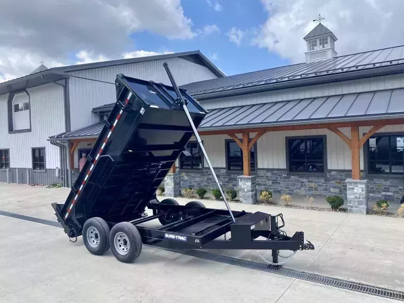 2026 Sure-Trac 7x12' Dump Trailer 14000# GVW * TELESCOPIC HOIST * FRONT/REAR BULKHEAD * INTEGRATED KEYWAY * 2' SIDES * UNDERBODY TOOL TRAY * ADJUSTABLE COUPLER * 110V CHARGER * UNDERMOUNT RAMPS * COMBO GATE * 12K DROP LEG JACK * SPARE MOUNT
