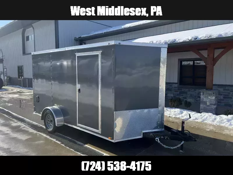 2026 Quality 7x12' Single Axle Enclosed Cargo Trailer 2990# GVW * BLACK POLYCOR .080 EXTERIOR * 4" FRAME * ELECTRIC BRAKES * SEMI-SCREWLESS * RAMP DOOR * PLYWOOD WALLS & FLOORS * TUBE WALL & CEILING STUDS * 16" O.C. WALL & FLOOR * RV DOOR * V-NOSE 1767932958