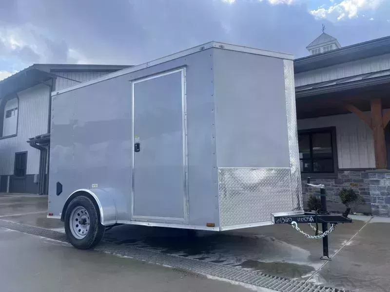 2025 Quality Cargo 6x14' Single Axle Enclosed Cargo Trailer 2990# GVW * 6'3 CEILING HEIGHT * SILVER EXTERIOR * PLYWOOD WALLS AND FLOOR * RV DOOR * 16" O.C. * TUBE STUDS * RAMP DOOR * V-NOSE