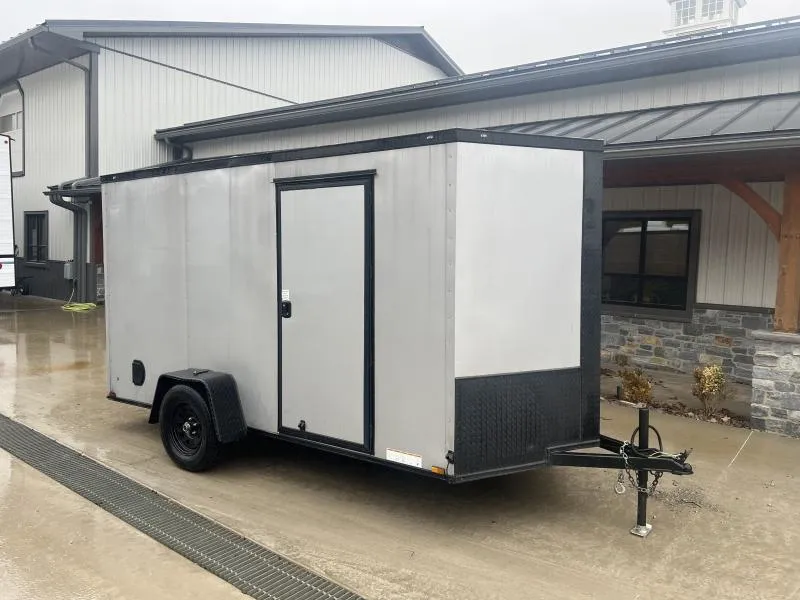 USED 2023 Xtreme Cargo 6x12' Enclosed Cargo Trailer 2990# GVW * 6'3" HEIGHT * 16" FLOOR CROSSMEMBERS * SILVER BLACKOUT EXTERIOR * .030 SEMI-SCREWLESS * RV DOOR * PLYWOOD WALLS AND FLOOR * TUBE STUDS
