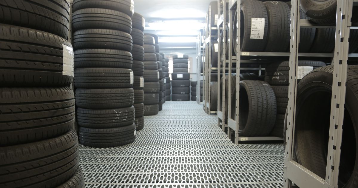 A silver rack of black trailer tires for trailer maintenance. " width="1200" height="630