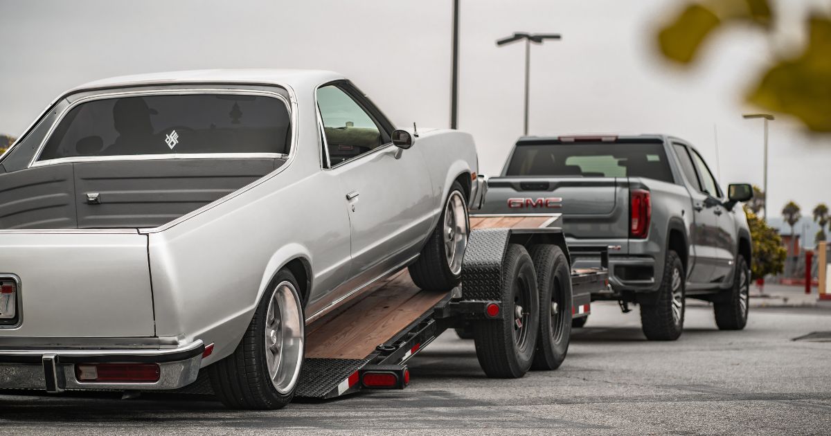 A car is loaded on a used trailer after the California Trailer team helped with choosing a trailer for the client's project. " width="1200" height="630
