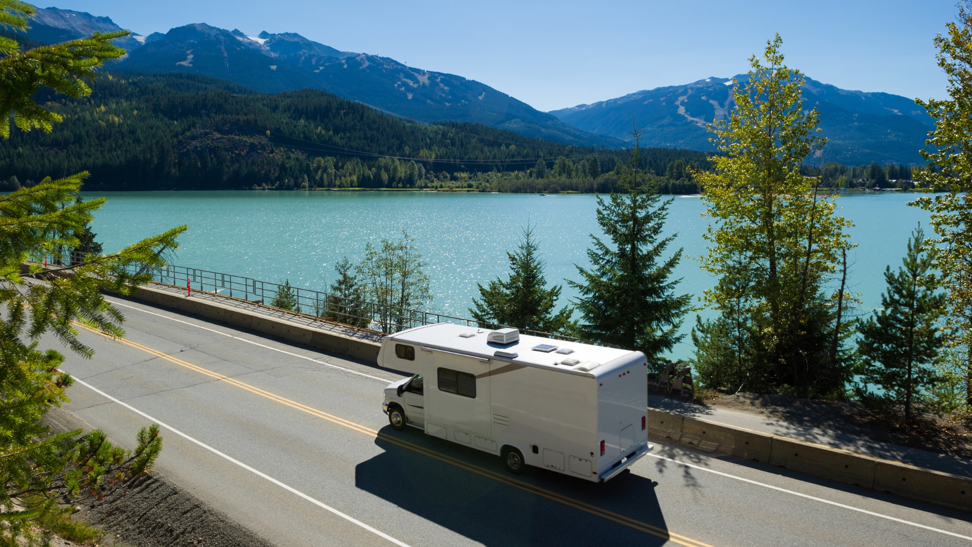 RV driving down a highway with beautiful view" width="1920" height="1080 RV driving down a highway with beautiful view" width="1920" height="1080